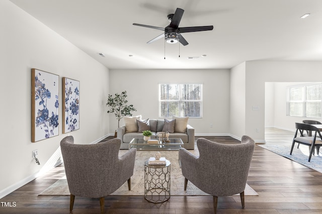 living room with ceiling fan and dark hardwood / wood-style floors