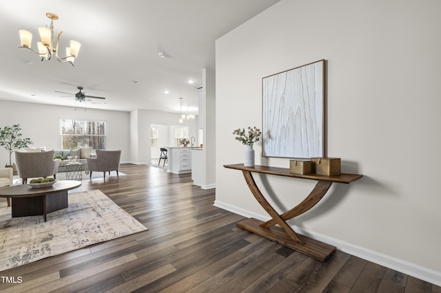 interior space with dark wood-type flooring, an inviting chandelier, and sink