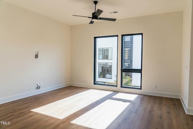 unfurnished room featuring ceiling fan and dark hardwood / wood-style flooring