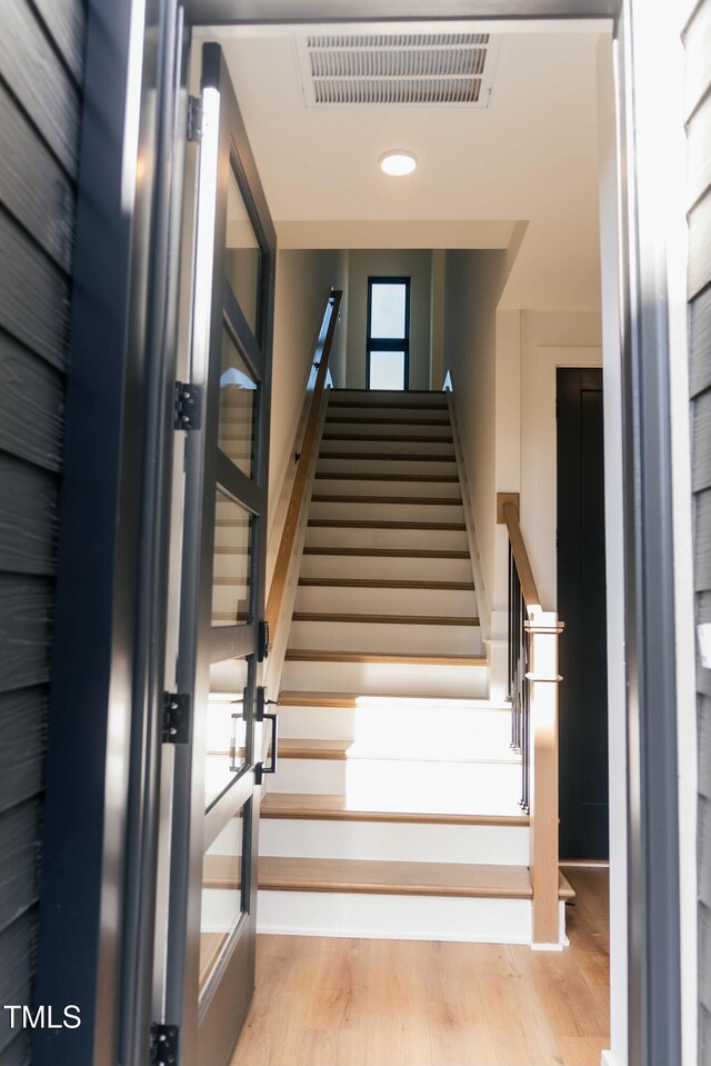 stairs featuring wood-type flooring