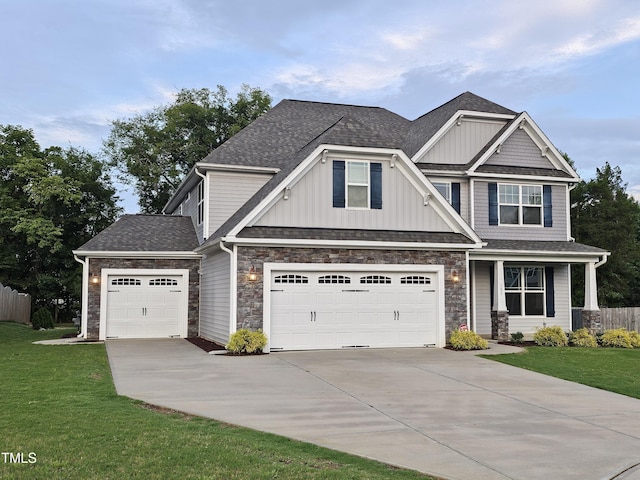 craftsman inspired home with a front yard and a garage