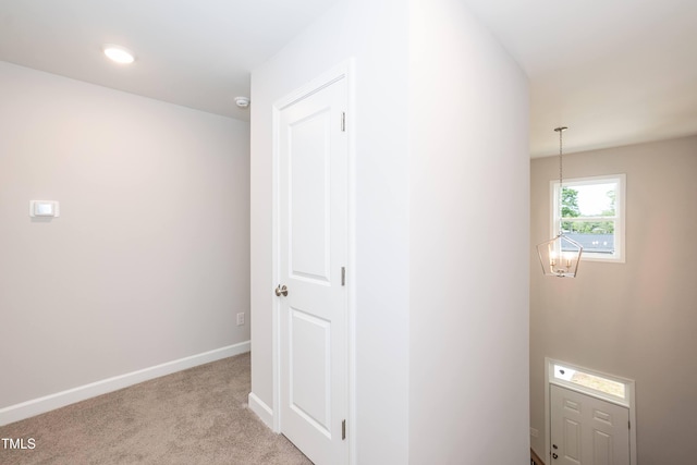 hallway featuring light colored carpet