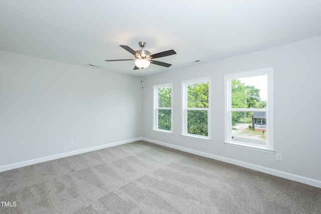 carpeted spare room with ceiling fan