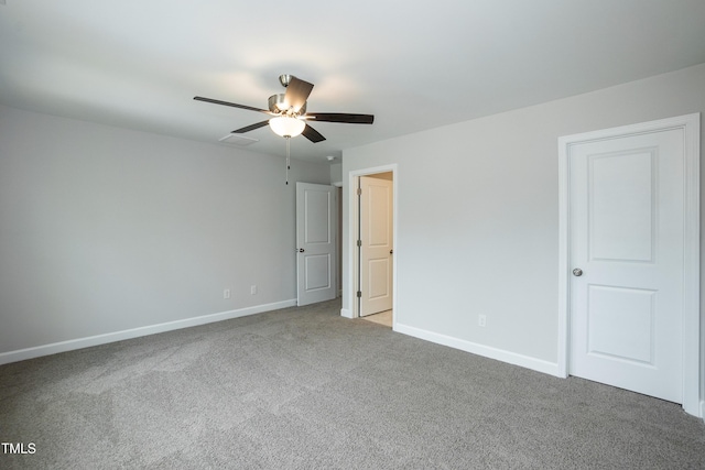 unfurnished room with ceiling fan and carpet