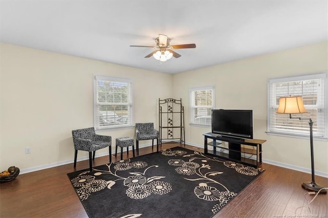 living area featuring hardwood / wood-style floors and ceiling fan