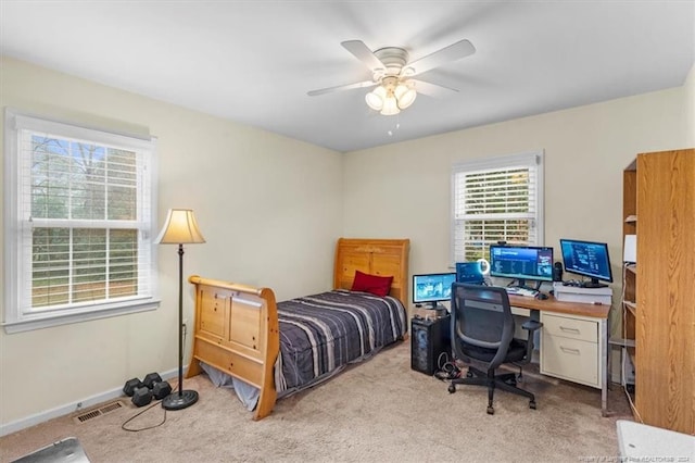 bedroom with ceiling fan and light colored carpet