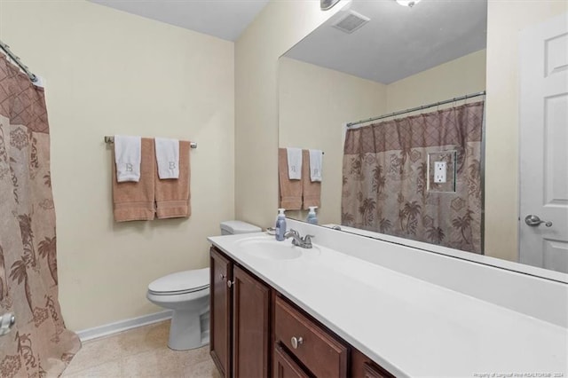 bathroom featuring tile patterned floors, vanity, and toilet