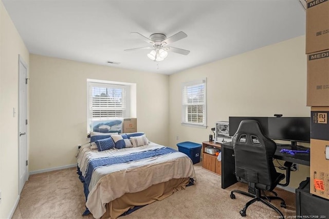 bedroom with ceiling fan and light colored carpet