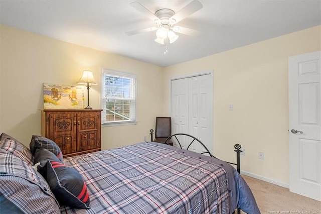 carpeted bedroom featuring ceiling fan and a closet