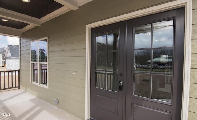 property entrance featuring a porch and french doors