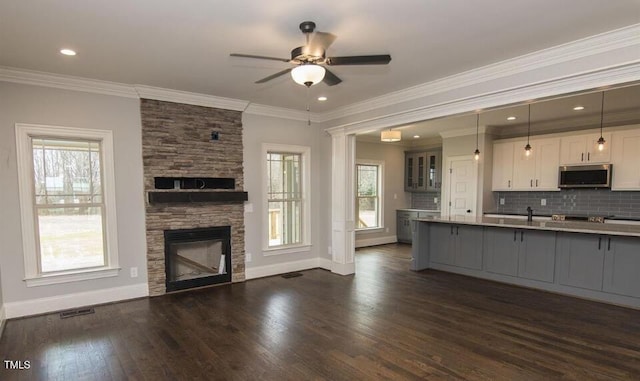 kitchen featuring a healthy amount of sunlight, white cabinetry, and dark wood-type flooring