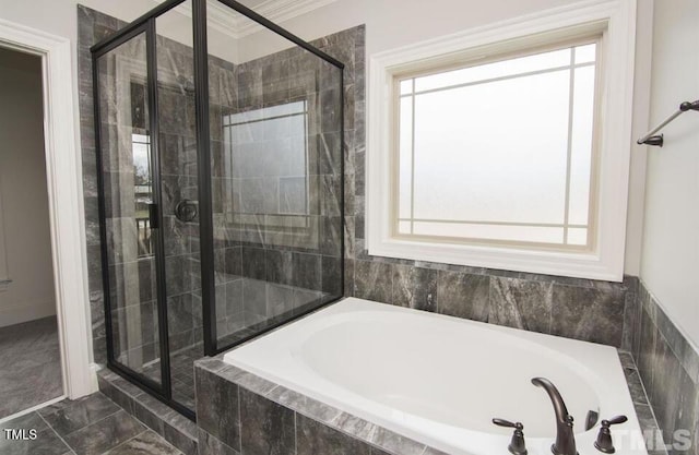 bathroom with independent shower and bath and ornamental molding