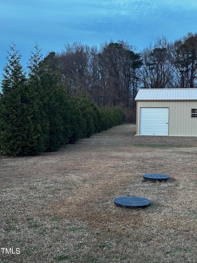 view of yard with a garage and an outdoor structure