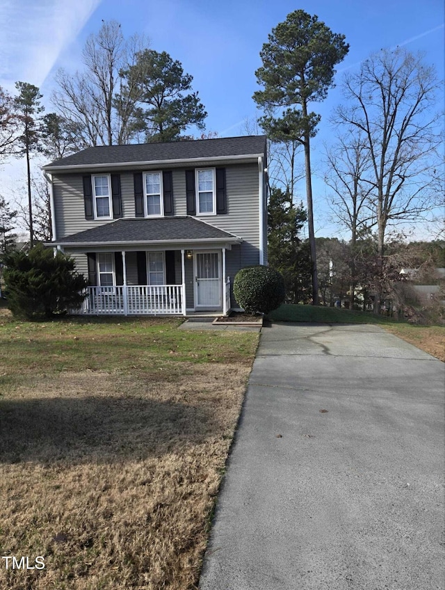 view of front facade featuring covered porch and a front yard