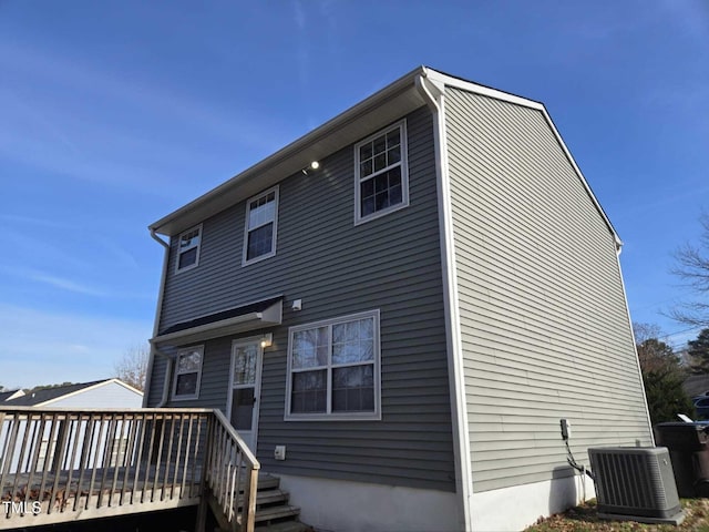 rear view of property with a wooden deck and central AC