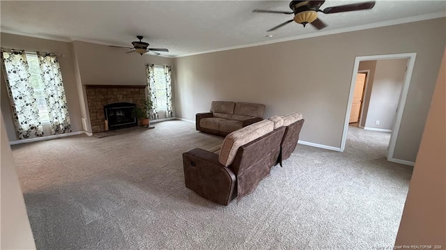carpeted living room with plenty of natural light, baseboards, ceiling fan, and crown molding