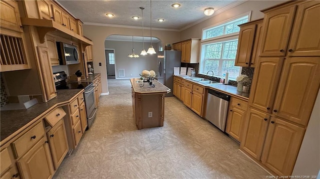 kitchen with decorative backsplash, ornamental molding, arched walkways, a sink, and appliances with stainless steel finishes