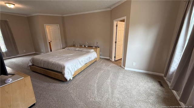 bedroom with crown molding, baseboards, visible vents, and carpet