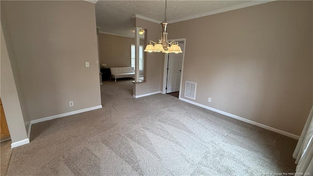 unfurnished dining area featuring visible vents, ornamental molding, carpet floors, an inviting chandelier, and baseboards