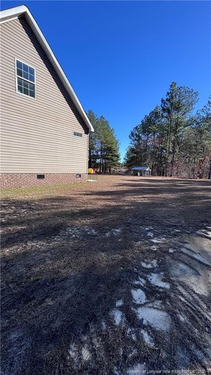 view of side of home with crawl space