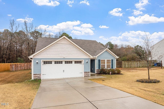 view of front of house featuring a front yard and a garage