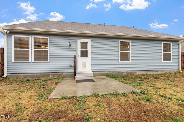 rear view of house featuring a lawn and a patio area