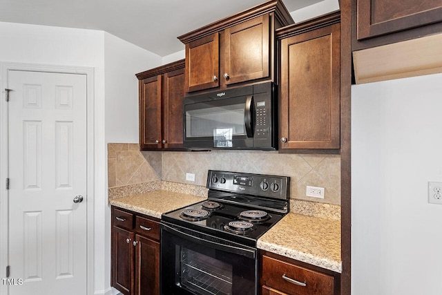 kitchen featuring decorative backsplash, dark brown cabinets, light stone counters, and black appliances