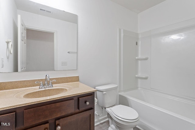 full bathroom with hardwood / wood-style flooring, vanity, toilet, and shower / tub combination