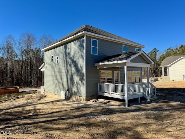 rear view of house featuring a deck