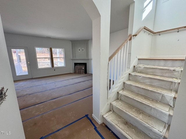 staircase featuring a fireplace