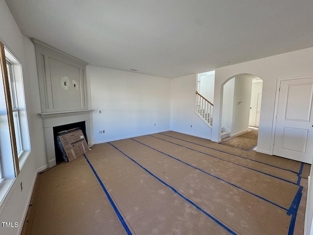 unfurnished living room featuring a fireplace