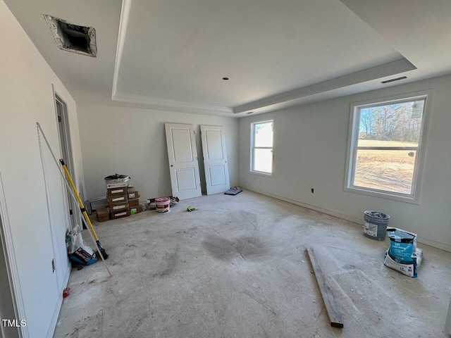 unfurnished bedroom with a raised ceiling