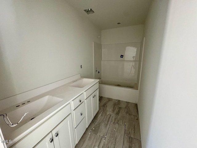 bathroom featuring shower / washtub combination and vanity