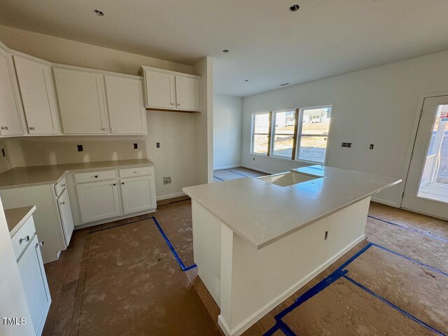 kitchen with a kitchen island and white cabinetry