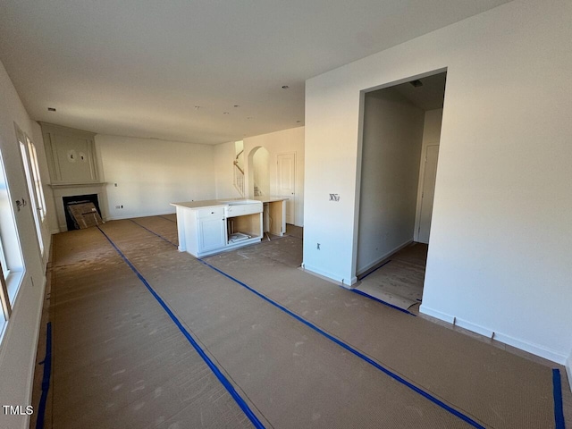 kitchen featuring a large fireplace and a center island