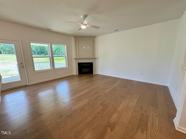 45 Covey Rise Way, Lillington, NC 27546 - unfurnished living room with wood finished floors, a ceiling fan, and a fireplace