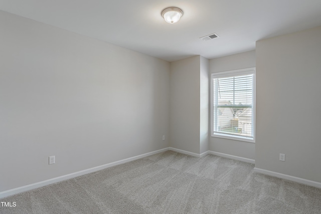 unfurnished room featuring light colored carpet