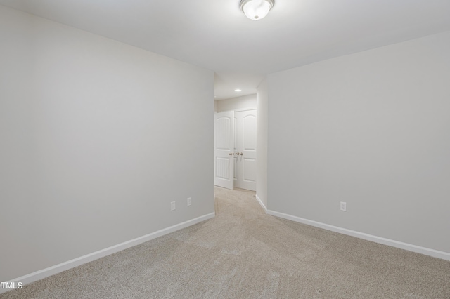 empty room featuring light carpet