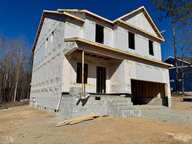 unfinished property featuring a garage