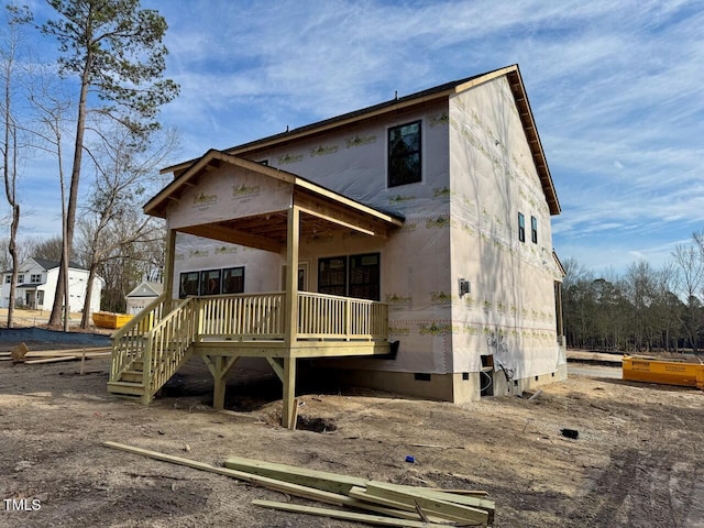 rear view of property featuring a deck