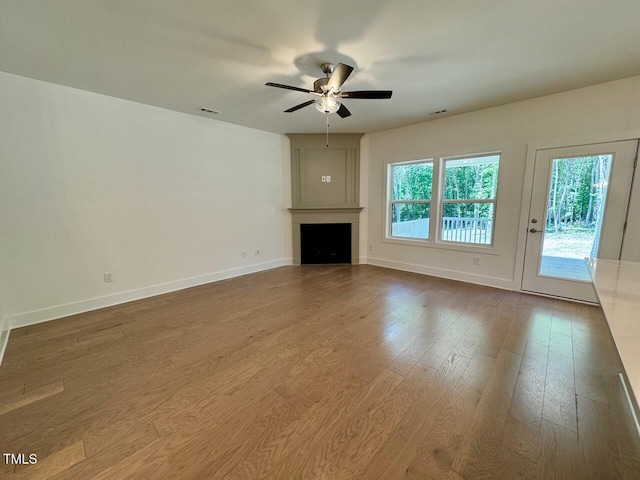 262 Grand Griffon Way, Lillington, NC 27546 - unfurnished living room with a ceiling fan, a fireplace, and wood finished floors