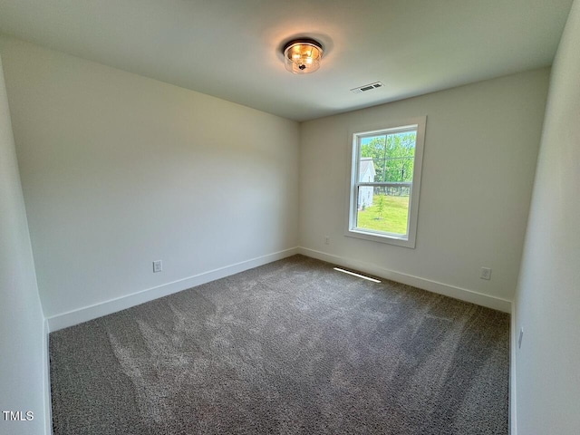 262 Grand Griffon Way, Lillington, NC 27546 - spare room featuring dark carpet and baseboards
