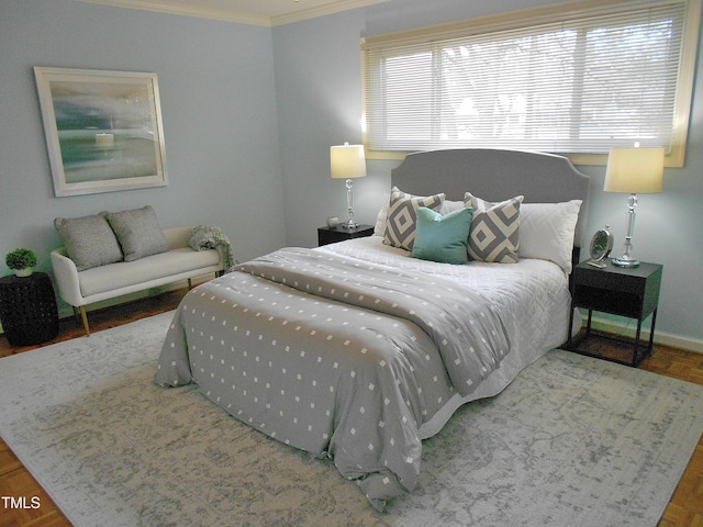 bedroom featuring hardwood / wood-style floors and crown molding