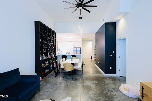 dining space with finished concrete floors and baseboards