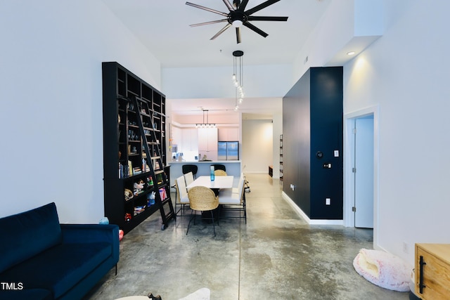 dining room featuring concrete floors and baseboards