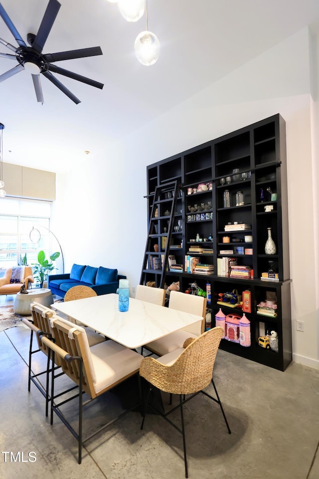 dining space featuring concrete floors and a ceiling fan