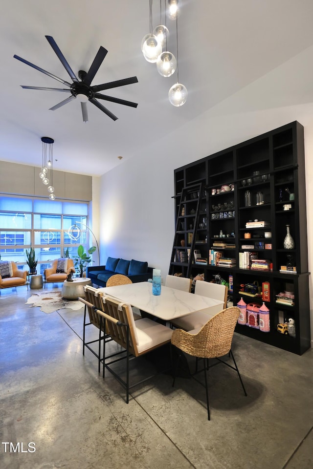 dining area featuring ceiling fan and concrete floors