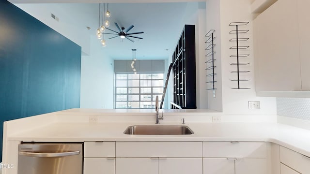 kitchen with dishwasher, light countertops, a sink, and visible vents