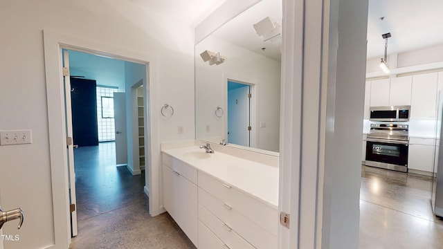 bathroom with concrete floors and vanity