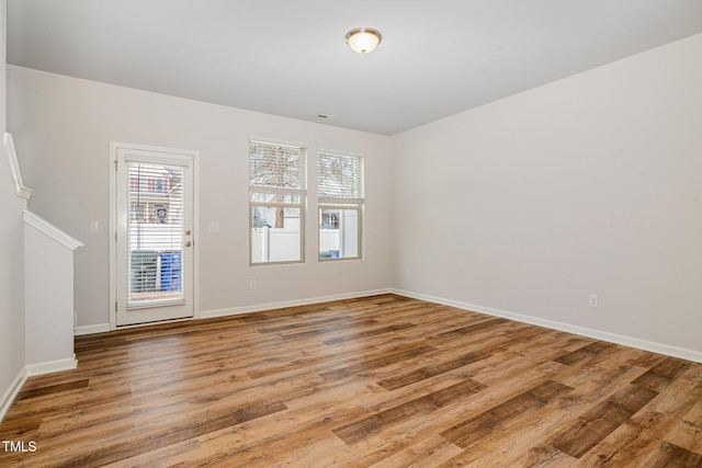 unfurnished room with hardwood / wood-style flooring